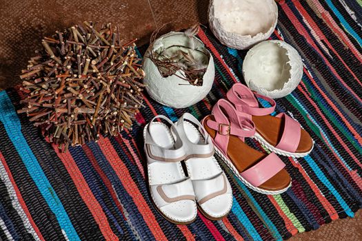 Different shoes with accessories on a studio background