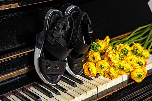 Different shoes with accessories on a studio background