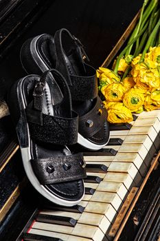 Different shoes with accessories on a studio background