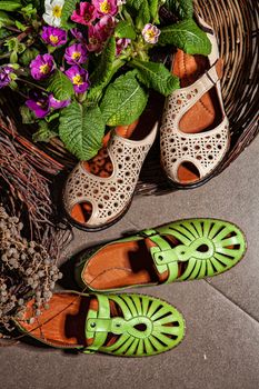 Different shoes with accessories on a studio background