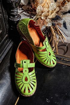 Different shoes with accessories on a studio background