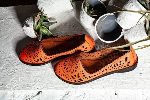 Different shoes with accessories on a studio background