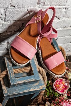 Different shoes with accessories on a studio background