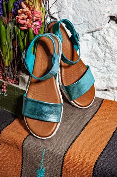Different shoes with accessories on a studio background