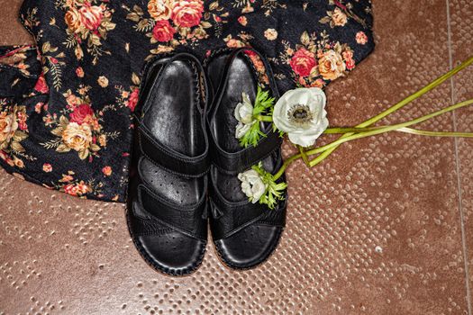 Different shoes with accessories on a studio background