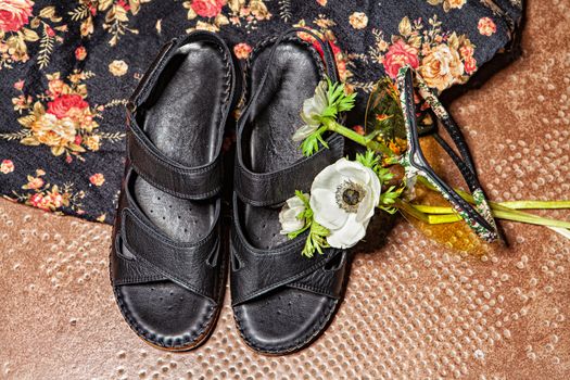 Different shoes with accessories on a studio background