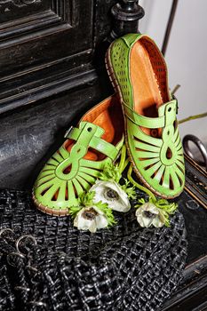 Different shoes with accessories on a studio background