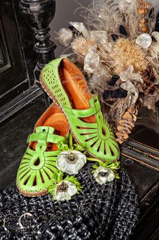 Different shoes with accessories on a studio background