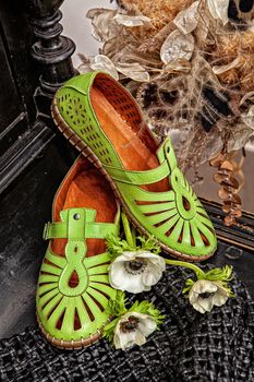 Different shoes with accessories on a studio background