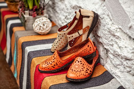 Different shoes with accessories on a studio background