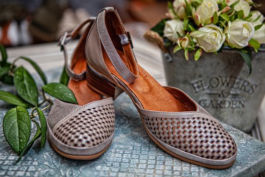 Different shoes with accessories on a studio background