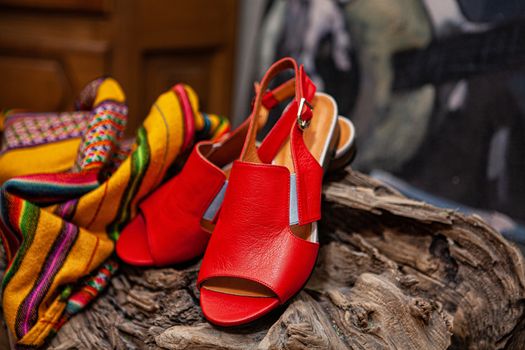 Different shoes with accessories on a studio background