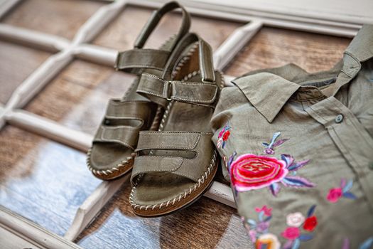 Different shoes with accessories on a studio background