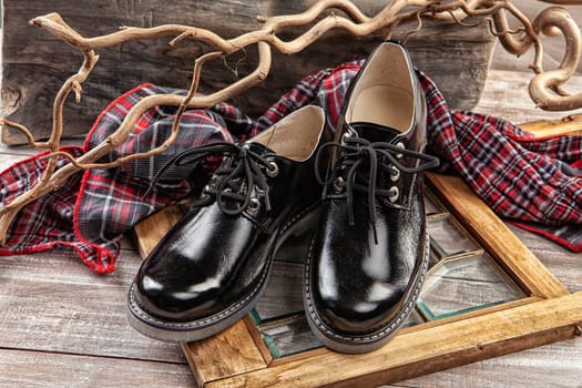 Woman's legs and shoes on a wooden background