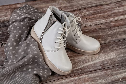 Woman's legs and shoes on a wooden background