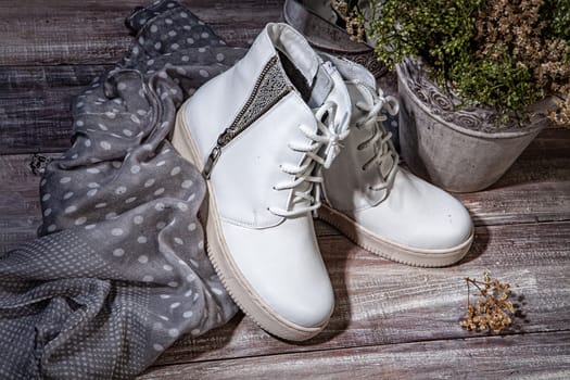 Woman's legs and shoes on a wooden background