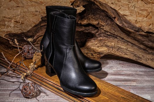 Woman's legs and shoes on a wooden background