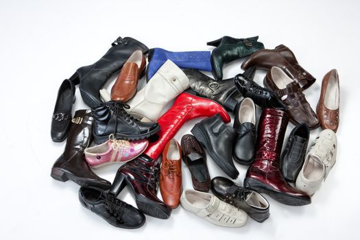 Different kinds of shoes on an isolated studio background