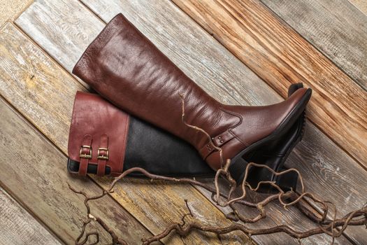 Different kinds of shoes on a wooden desk