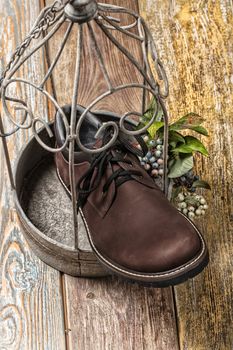 Different kinds of shoes on a wooden desk