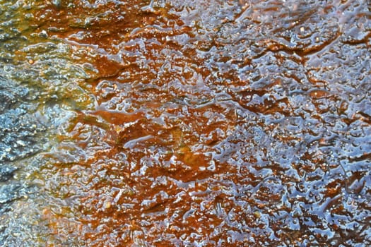 A close up of a rock with a coloured pattern on it