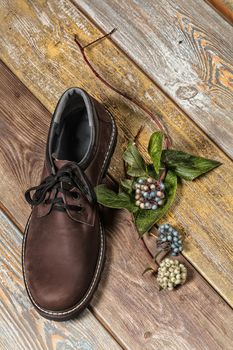 Different kinds of shoes on a wooden desk