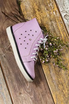 Different kinds of shoes on a wooden desk