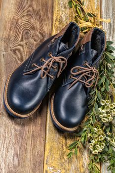 Different kinds of shoes on a wooden desk