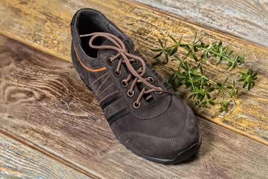 Different kinds of shoes on a wooden desk