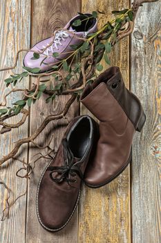 Different kinds of shoes on a wooden desk
