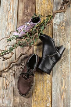 Different kinds of shoes on a wooden desk