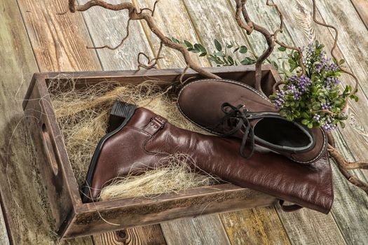 Different kinds of shoes on a wooden desk