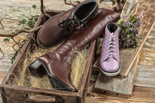 Different kinds of shoes on a wooden desk