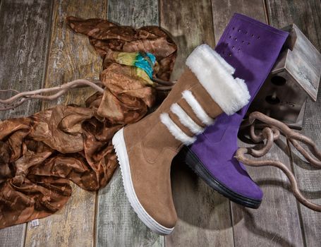 Different kinds of shoes on a wooden desk