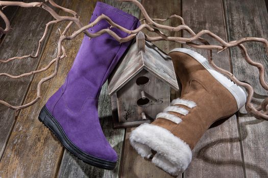 Different kinds of shoes on a wooden desk