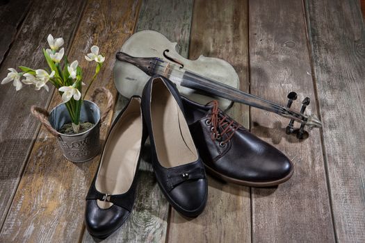 Different kinds of shoes on a wooden desk