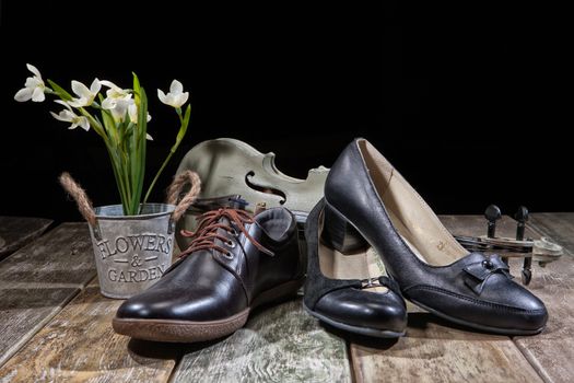 Different kinds of shoes on a wooden desk