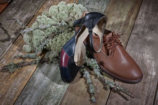 Different kinds of shoes on a wooden desk