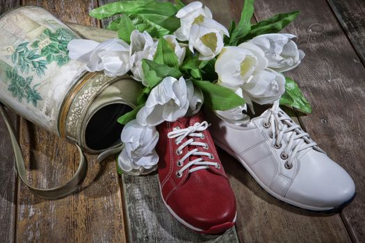 Different kinds of shoes on a wooden desk