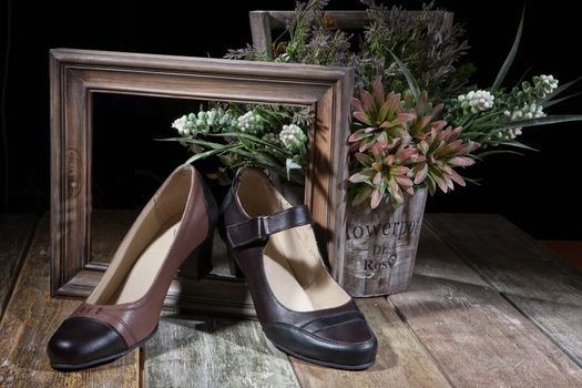 Different kinds of shoes on a wooden desk