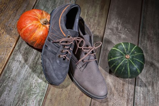 Different kinds of shoes on a wooden desk