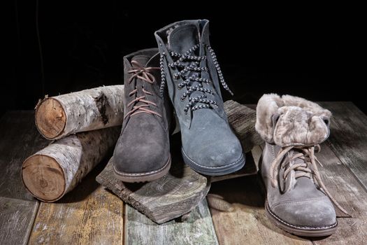 Different kinds of shoes on a wooden desk