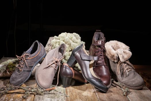 Different kinds of shoes on a wooden desk