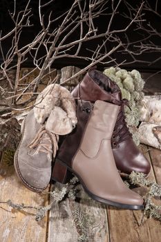 Different kinds of shoes on a wooden desk