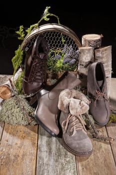 Different kinds of shoes on a wooden desk