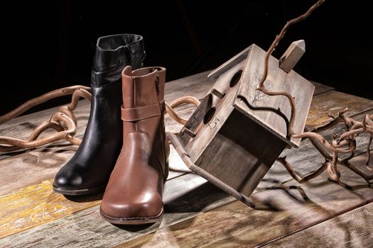 Different kinds of shoes on a wooden desk