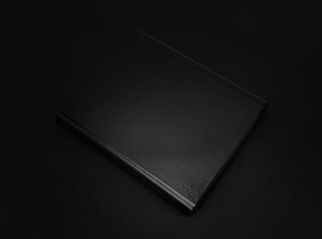 Black leather folder isolated on black background. With clipping path