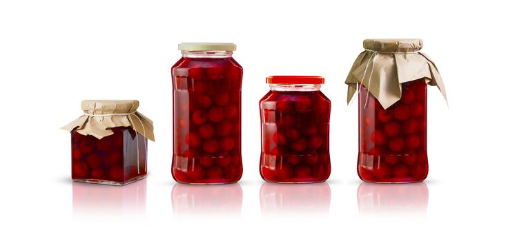 Cherry compote in glass jars of different shapes. Isolated on white background. With clipping path