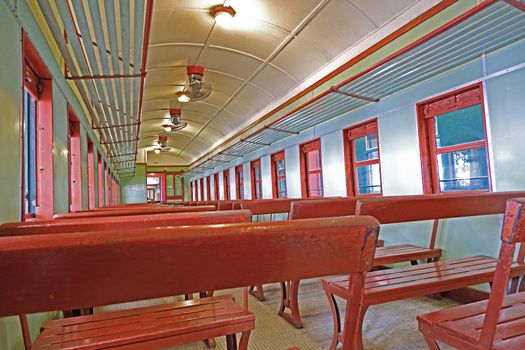 The historical vintage train with retro wooden passenger chairs, lamp and fan