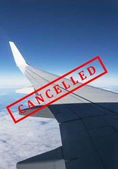 flight cancellation. commercial airplane flight over the clouds with red stamp text trip cancelled from city shutdown and border closed, effect from COVID-19 Coronavirus outbreak